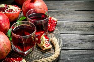 Pomegranate juice in a glass on tray. photo