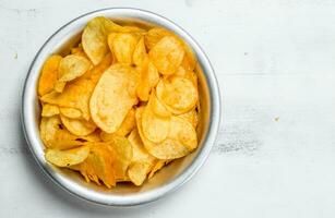 Potato chips in the bowl . photo