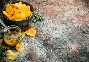 Potato chips with French mustard and rosemary. photo