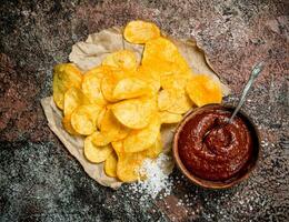 Potato chips with tomato sauce and salt. photo