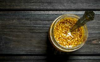 Mustard in a glass jar. photo