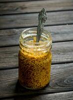 Mustard in a glass jar. photo