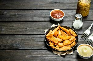 Baked potato slices with different sauces. photo