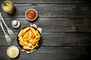 Baked potato slices with different sauces. photo