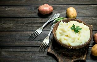 Mashed potatoes with a sprig of parsley . photo