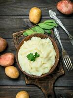 Mashed potatoes with a sprig of parsley . photo