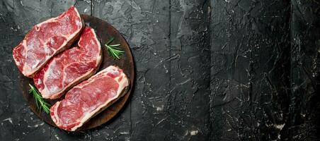 Raw beef steaks on cutting Board. photo