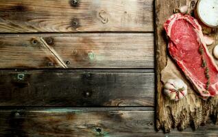 Raw beef steak with salt and garlic. photo