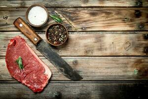 Raw marbled beef steak with spices. photo