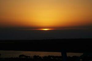 calm sunset in Trusia with views of the beach and swimming pools photo