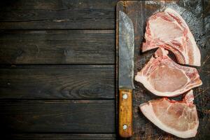 Raw pork steaks on the bone. photo