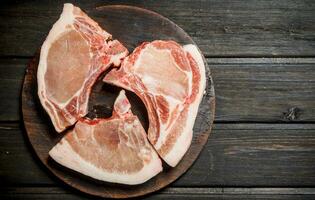 Raw pork steaks on the bone. photo