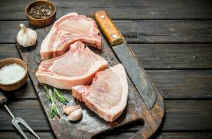 Raw pork steaks on the bone. photo
