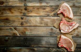 Raw pork steaks on the bone. photo