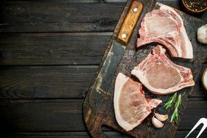 Raw pork steaks on the bone. photo