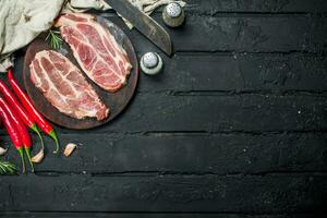 Raw pork steaks with aromatic and herbs and spices. photo