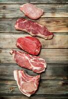 Raw meat. Pork and beef steaks. photo