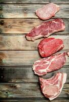 Raw meat. Pork and beef steaks. photo