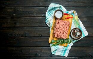 Raw minced meat with spices and herbs . photo