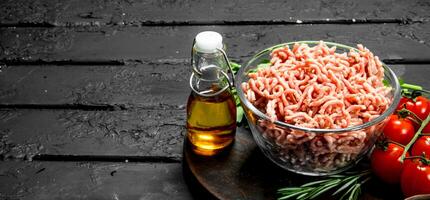 Raw minced meat in a bowl with spices and herbs. photo