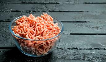 Raw minced meat in a glass bowl . photo