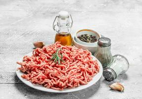 Raw minced meat with spices and herbs . photo