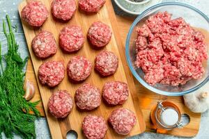 Raw beef meatballs with spices and fragrant dill . photo