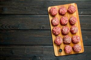 Raw meat meatballs with spices . photo