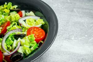 Vegetable salad. Salad of cucumbers, tomatoes and red onions with spices and olive oil. photo