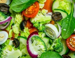 Vegetable salad. Salad of tomatoes, cucumbers and quail eggs with olive oil. photo