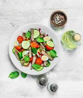 Healthy salad. Salad with boiled beef, vegetables and quail eggs. photo