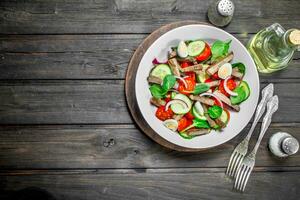 Healthy salad. Salad with boiled beef, vegetables and quail eggs. photo