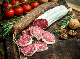 Salami with tomatoes and spices. photo