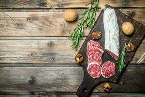 Salami with nuts and rosemary. photo