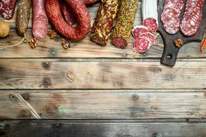 Various types of salami on a Board with nuts. photo