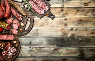 Various types of salami on a Board with nuts. photo