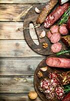 Various types of salami on a Board with nuts. photo