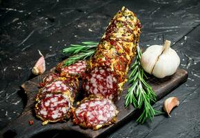 Fragrant salami with herbs and spices. photo