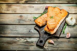 Grilled salmon fillet with garlic and rosemary. photo