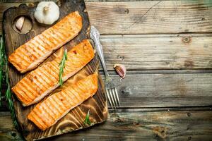 Grilled salmon fillet with garlic and rosemary. photo