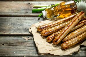 Grilled sausage of pork and beef on paper. photo