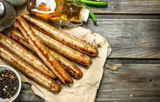 Grilled sausage of pork and beef on paper. photo