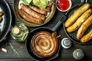 Assortment of different fried sausages with sauces. photo