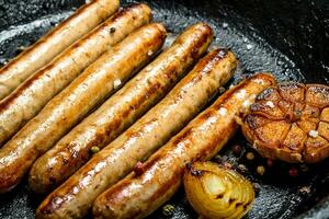 Grill the sausages in the pan. photo