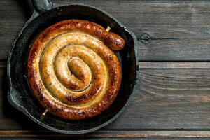 Grill the sausages in the pan. photo