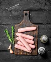 Boiled sausages with salt and pepper. photo