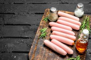 Boiled sausages with salt and pepper. photo