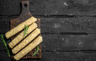 Raw sausages with seasonings and herbs. photo