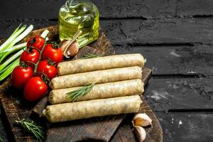 Raw sausages with seasonings and herbs. photo