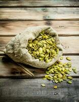 Pumpkin seeds in a bag. photo